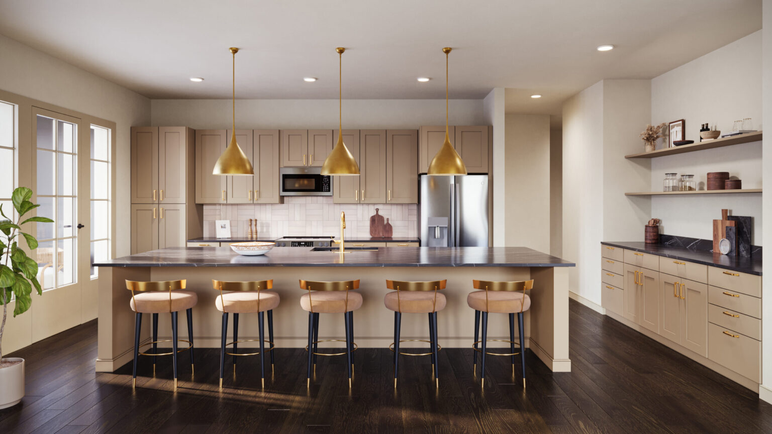 Modern apartment kitchen with breakfast bar, gold finishes, and stainless steel appliances at Laurel, a Collective.