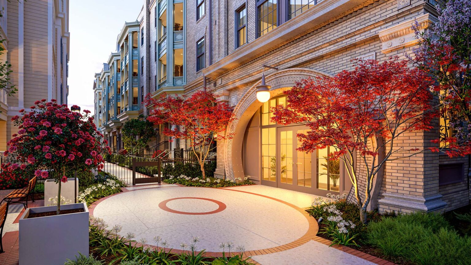 Landscaped courtyard at Laurel, A Collective with flowering trees, brick pathways, and arched entry