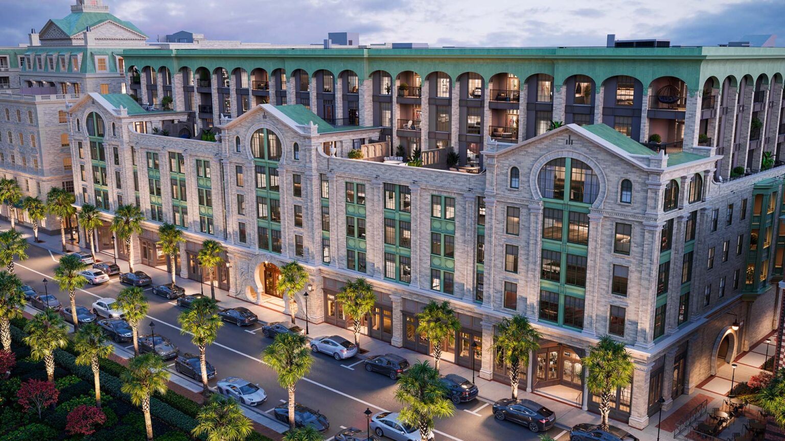 A grand, aerial exterior view of the Laurel building at dusk, showcasing a stunning multi-story tan brick facade with intricate architectural details.